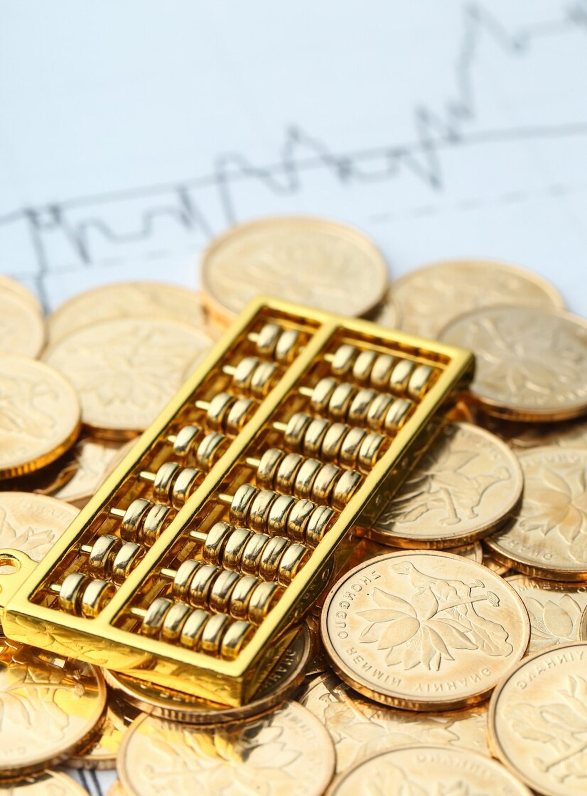 golden-abacus-with-chinese-rmb-gold-coins-as-background_1387-46